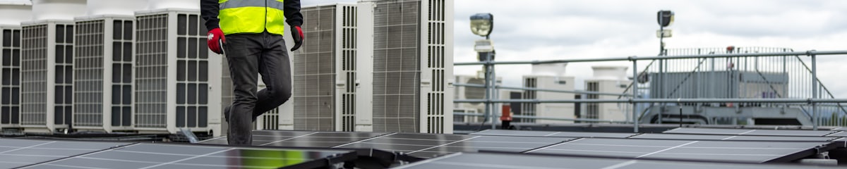 Flat commercial rooftop with HVAC units and solar panels